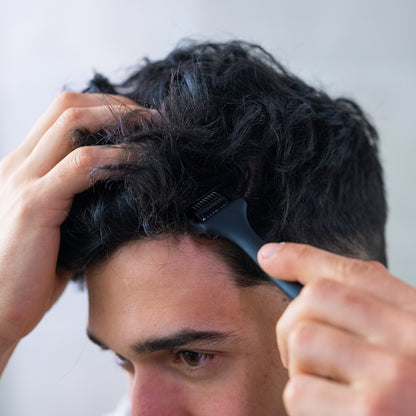 Man massaging the ZENLUCA Hair Growth Dermaroller through his hair close to the scalp