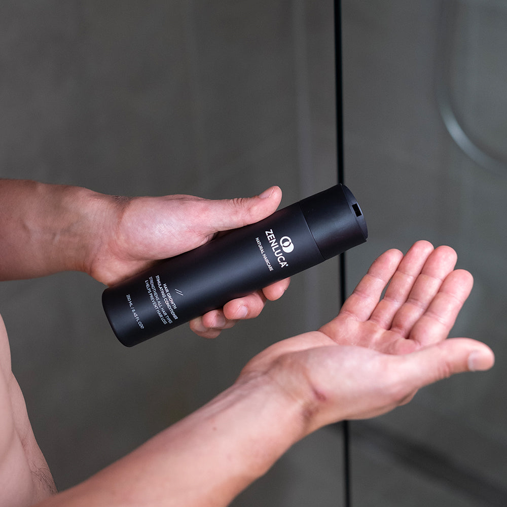 Person pouring a ZENLUCA Natural Haircare product from the Signature Set into their hand